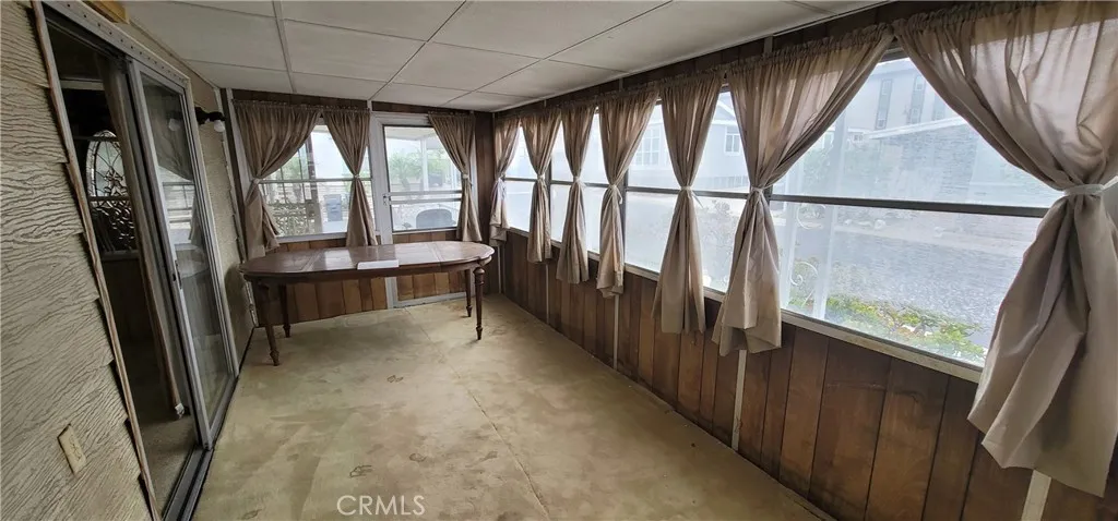 Table is blocking the direct access to the front porch for this enclosed porch.