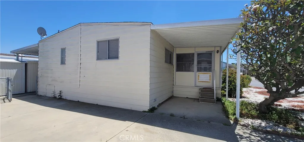 Back of the unit and 2nd driveway with direct access to enclosed porch. room for 2 vehicles to park here.