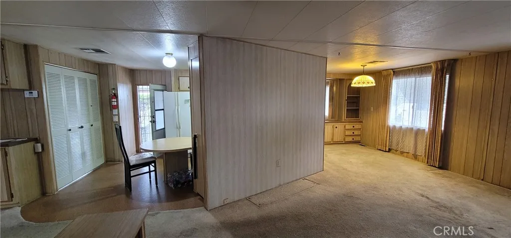 Kitchen border wall with living room. Remove to open up the space and make it more spacious.