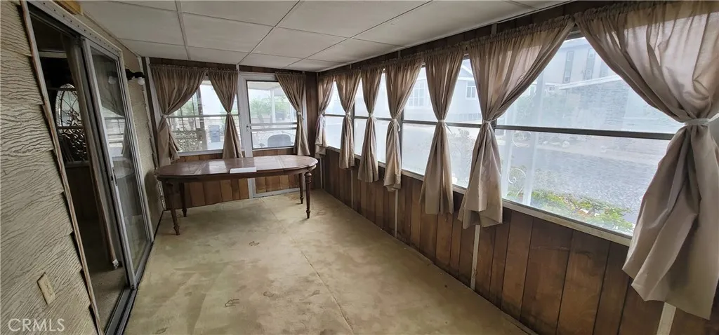 Table is blocking the direct access to the front porch for this enclosed porch.