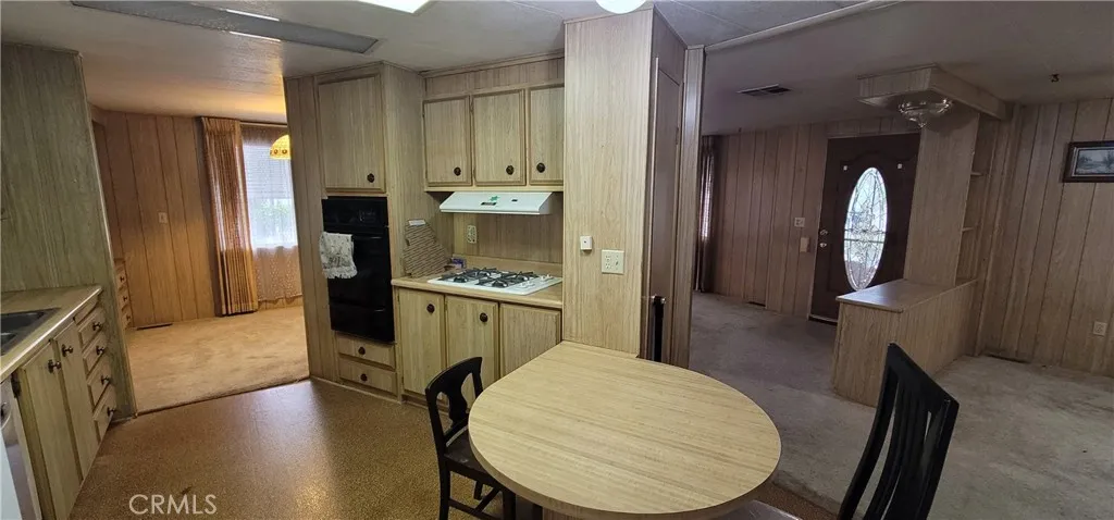 View from back door towards kitchen border wall with living room. Removal of this wall would open the space and make it more roomy for entertaining. (see closed unit #391 for improvement ideas)