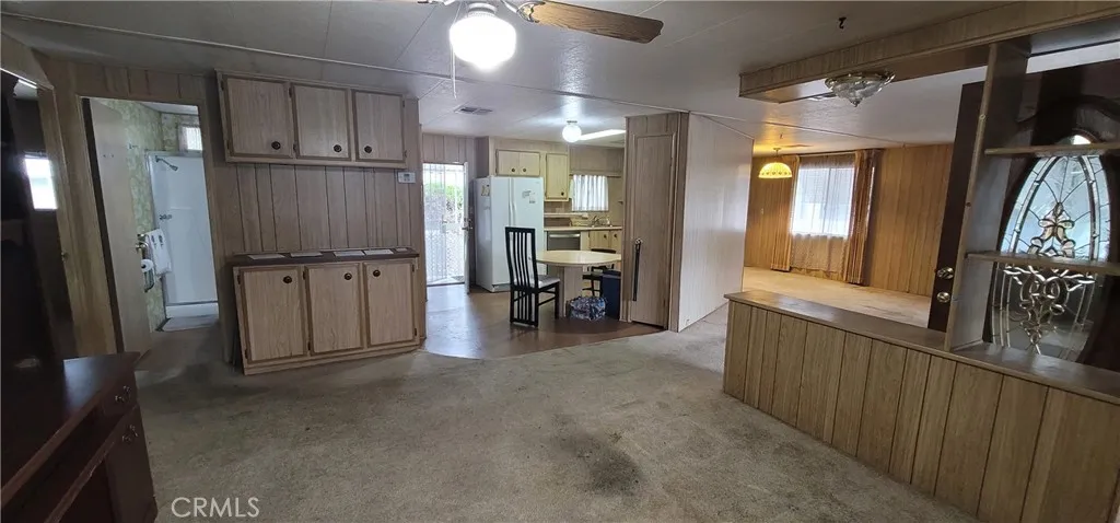 View from the doorway of the enclosed porch towards the kitchen and guest bathroom.