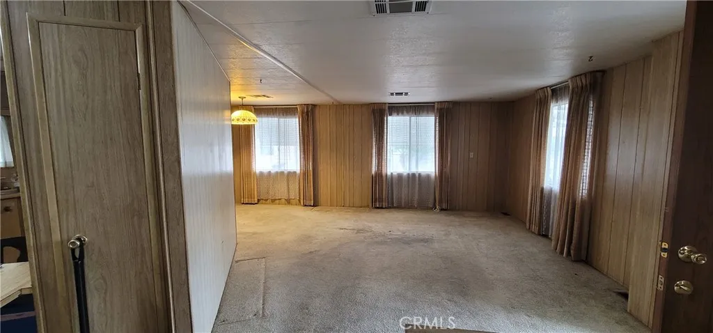 This wall is not load bearing according to other units that has this same floorplan in this area. (see sold unit #391 for improvement ideas)