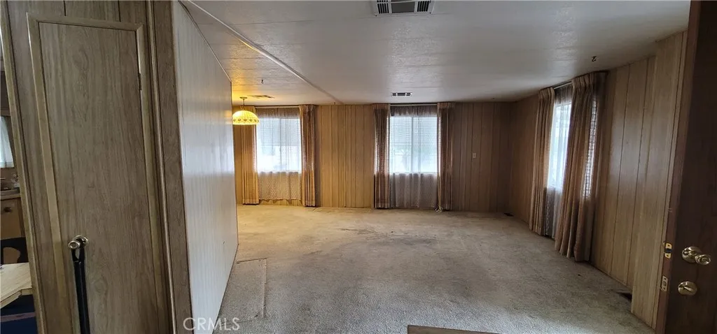 This wall is not load bearing according to other units that has this same floorplan in this area. (see sold unit #391 for improvement ideas)