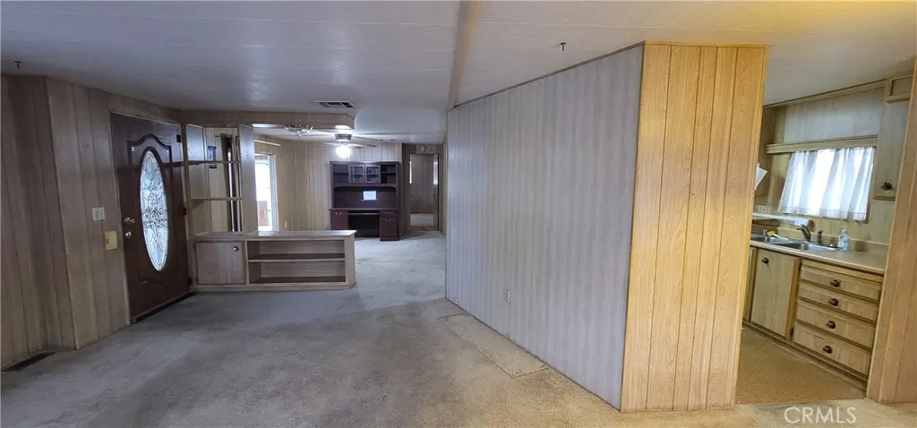 View of front door and pony wall to family room area, border wall with kitchen. Remove these two walls to make the unit much more spacious. (see closed unit #391 for improvement ideas)