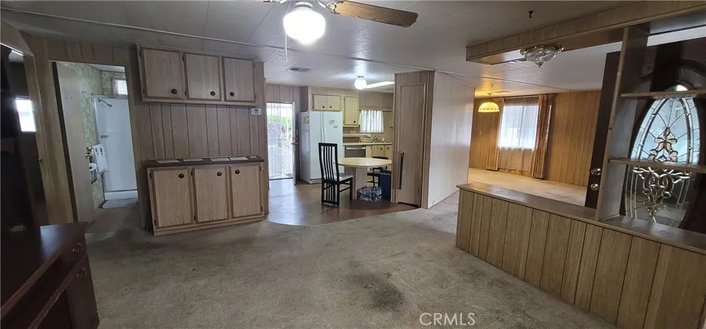 View from the doorway of the enclosed porch towards the kitchen and guest bathroom.