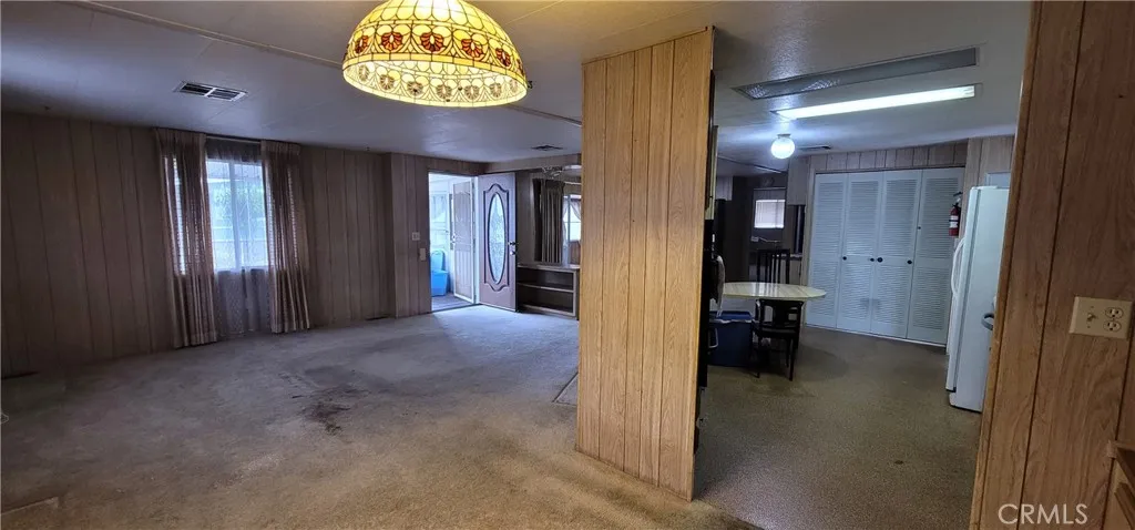 Wall dividing the kitchen and living room can be removed to open the space up.