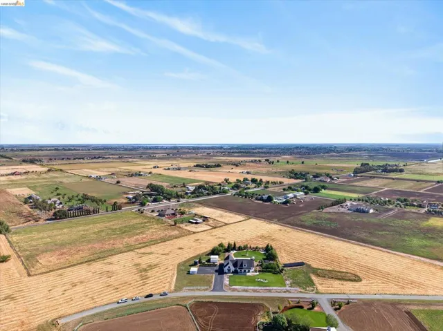 Overview of rural landscape featuring rows of crops