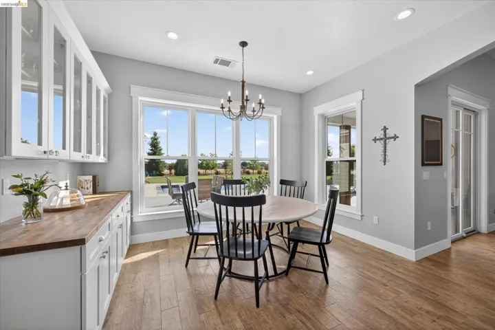 Dining space with a chandelier and wood finished floors