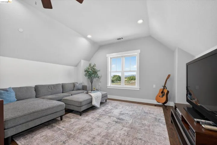 Living area featuring a ceiling fan, wood finished floors, and recessed lighting