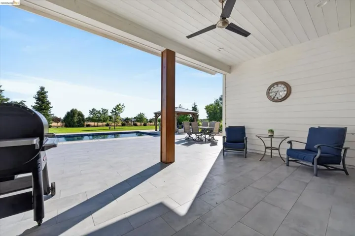 View of patio / terrace with an outdoor pool, outdoor dining space, grilling area, and ceiling fan