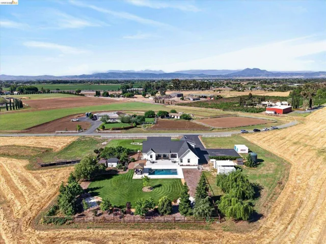 Overview of rural landscape featuring a mountain backdrop