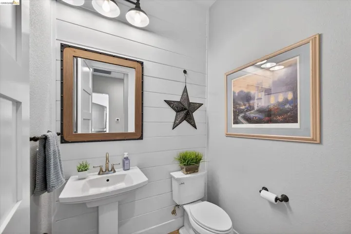 Bathroom with toilet and wood walls