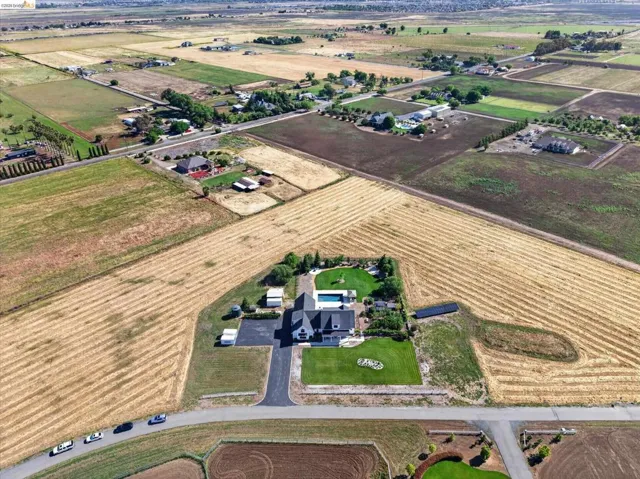 Aerial overview of property's location featuring rural landscape and large plots for crops