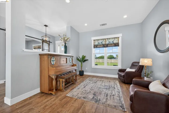 Living area featuring wood finished floors and hanging lights