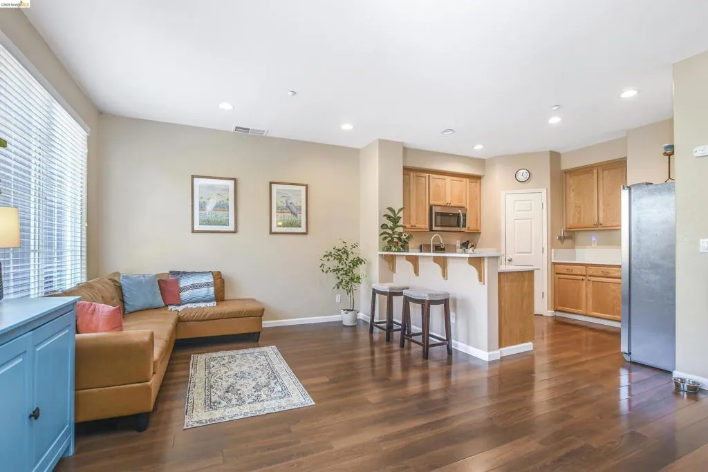 Open-concept living space featuring wood-finish flooring
