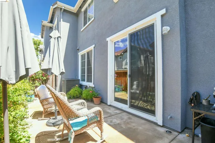 Private concrete patio area with sliding glass door access