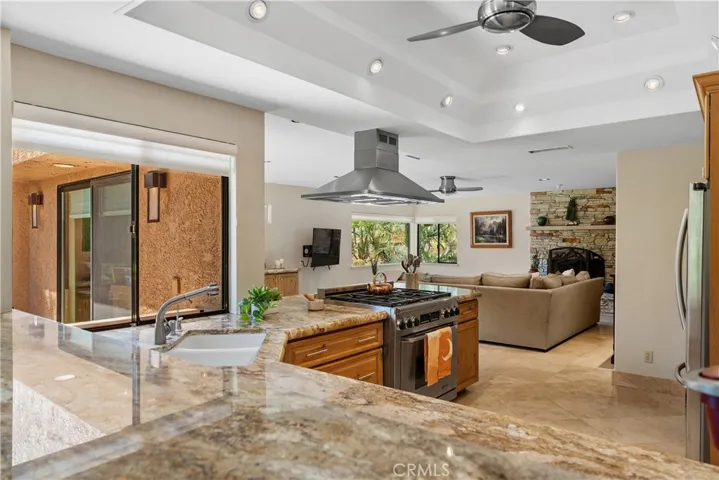 Large open gourmet kitchen featuring stainless steel appliances, granite counter tops and an abundance of cabinet storage.