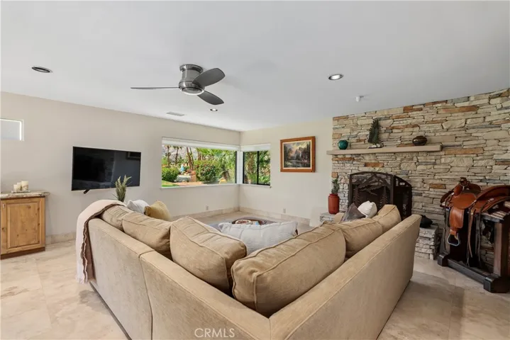 Extended 600 square feet of family room space with stunning views and anchored with a cozy stacked stone fireplace.