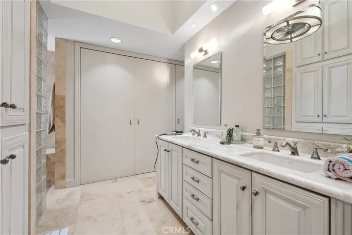 Primary bathroom with dual vanities.