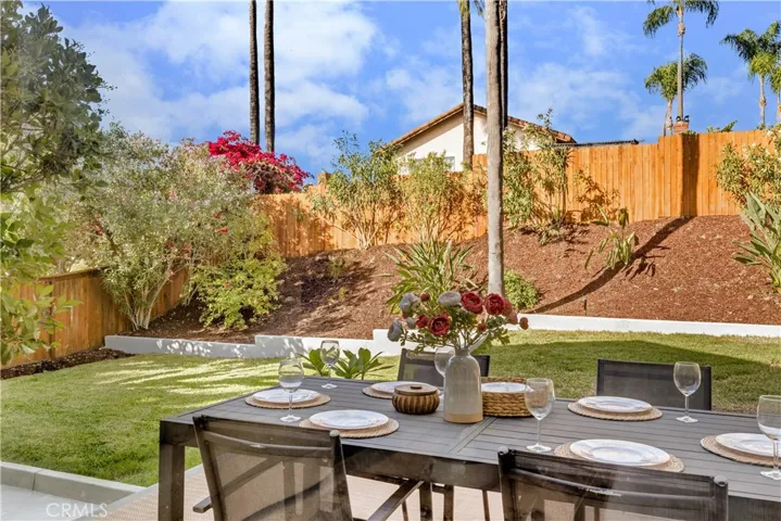 The outdoor dining area, set amidst the beautiful garden, perfect for hosting or simply enjoying the view.