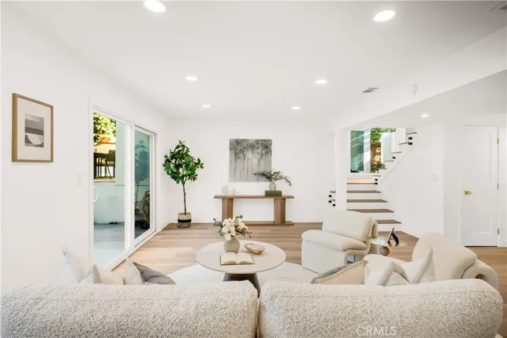 Inviting and tranquil living space with modern furnishings, perfect for relaxation. The open layout flows seamlessly into the outdoors, offering a serene environment.