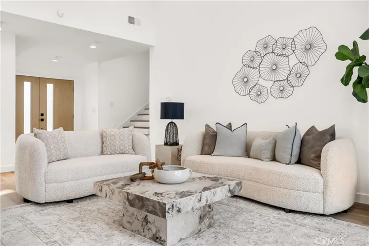Bright and stylish living area featuring plush seating, modern decor, and an inviting atmosphere.
