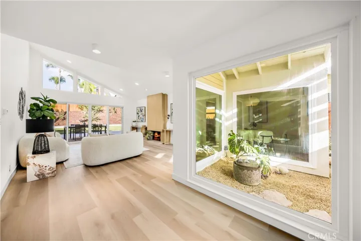 Bright and airy living space with a large window offering a peaceful view.