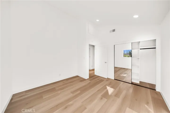 Third bedroom featuring high ceilings, providing an open and airy feel, with ample closet space.