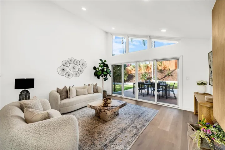 Bright and airy living area with large windows, offering a seamless connection to the backyard patio for effortless indoor-outdoor living.