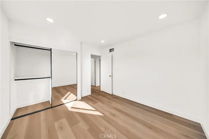 Another angle of the second bedroom, showcasing its spacious layout and large closet space.