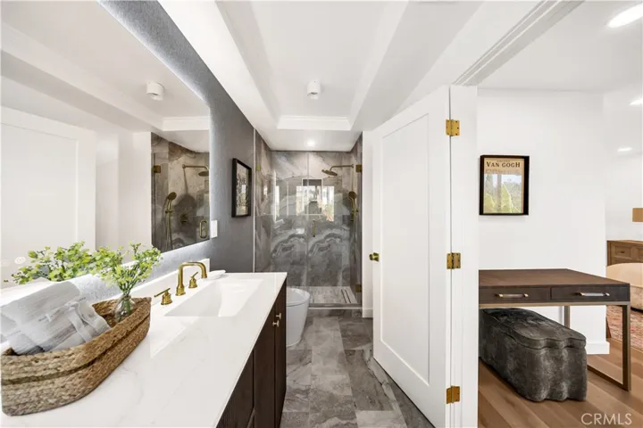 Luxurious master bathroom featuring a modern design with elegant finishes, including sleek marble tile and stylish vanity, offering a spa-like atmosphere.