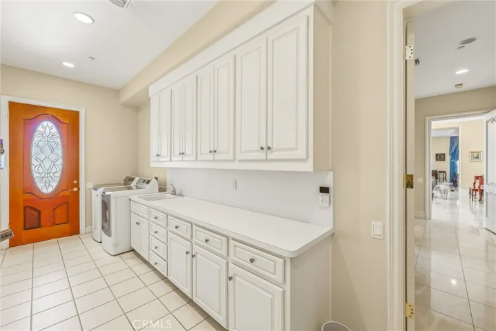 Laundry room is off the backyard and 4 car garage.