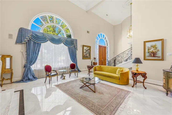 Natural light fills this refined living room, framed by soaring ceilings and classic design.