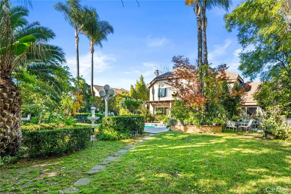 View from towards the back of the lot looking towards the home.  Well-manicured grounds & total privacy