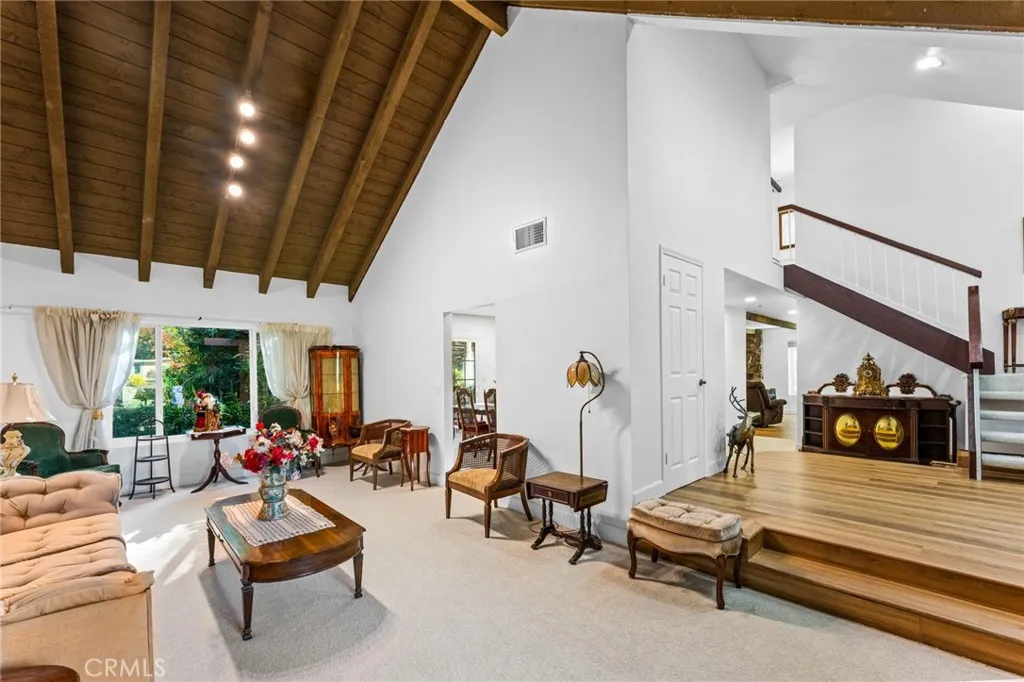 Living room looking towards front grand entry & stairs