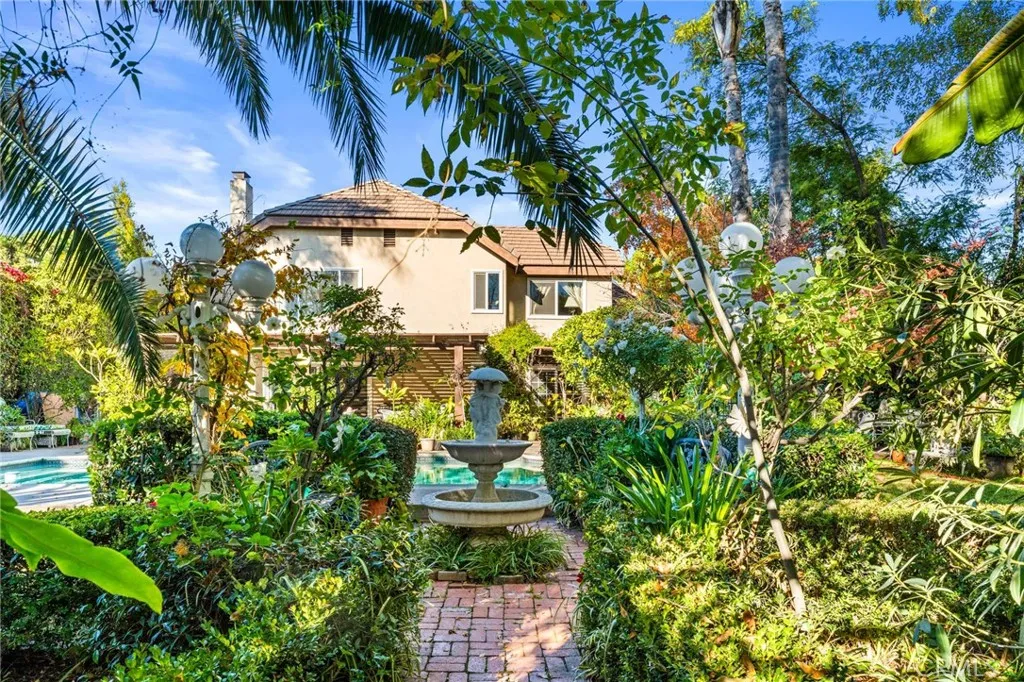 Serene water feature in between the pool & the rear area of this amazing lot