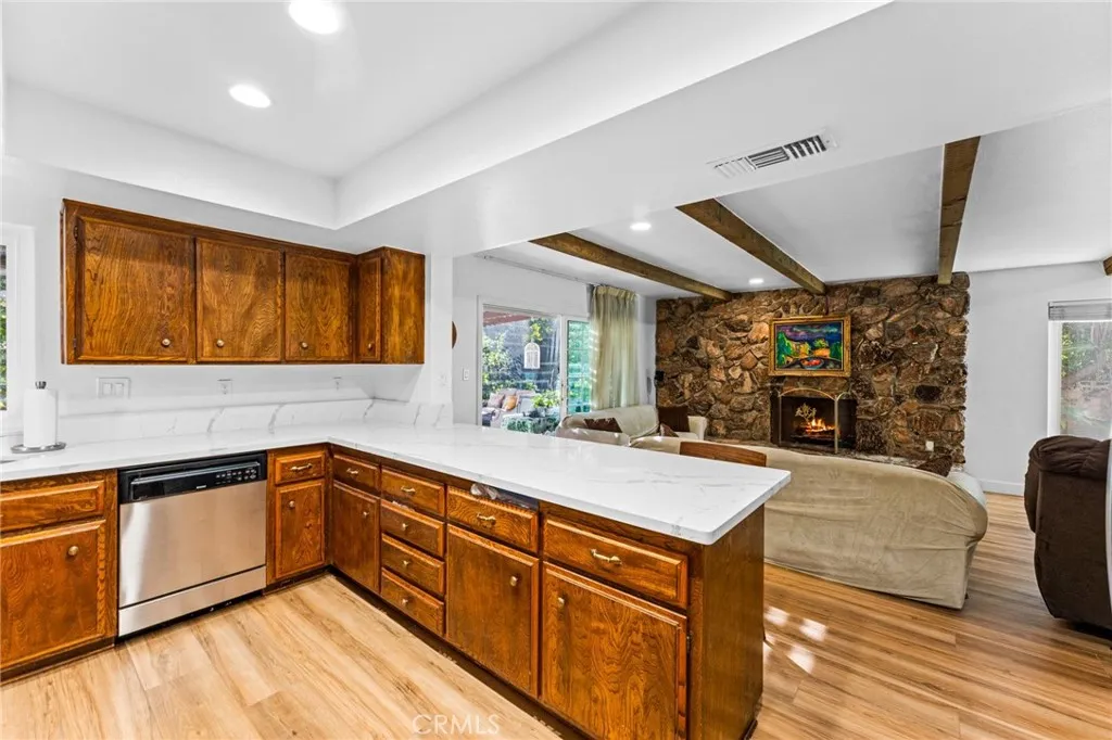 Kitchen boasts white quartz counters and flows seamlessly into family room