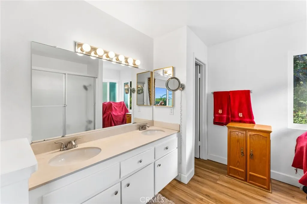 Primary bath has dual vanities, plenty of natural light & overlooks the private back yard