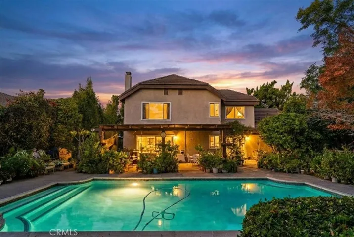 Gorgeous view of the pool and home at sunset
