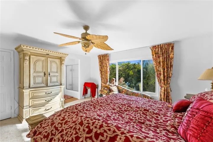 Spacious primary suite overlooks serene back yard.  Notice the primary en-suite bath for extra privacy