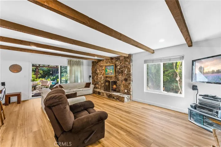 Open family room with neutral laminate wood flooring