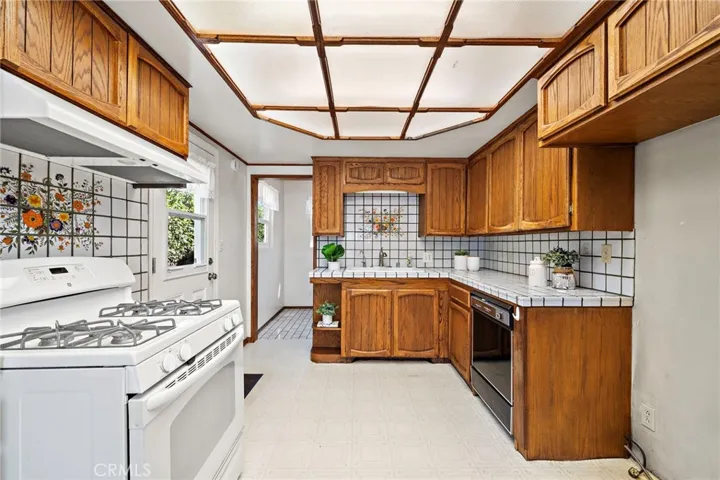 Light and Bright Kitchen with Tile Countertops and Backsplash