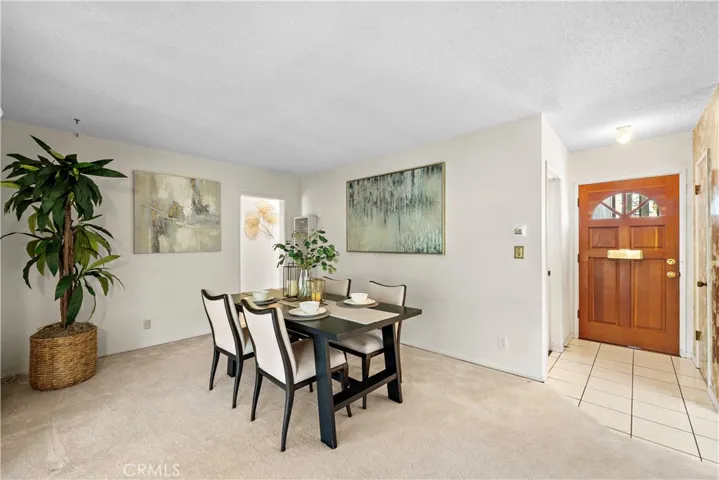 Entry Door to Tiled Foyer and Living Room that's Currently an Extra Large Formal Dining Room