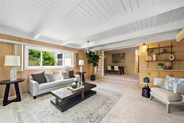 What a Great Living Space this Family Room Addition is with its Open Beam Ceiling, A/C, Dual Pane Windows and Wall of Sliders to the Tropical Backyard