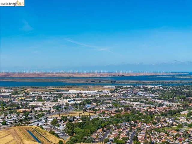 Aerial perspective of suburban area featuring a nearby body of water