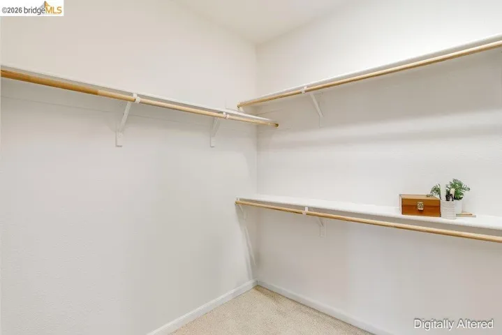 Walk in closet featuring light carpet