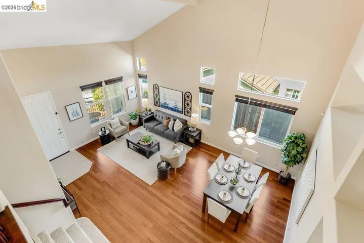 Living area featuring wood finished floors and a high ceiling