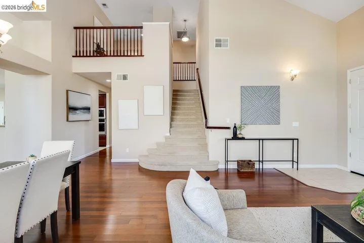 Living room featuring hardwood / wood-style flooring and a high ceiling