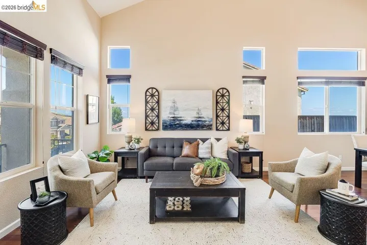 Living area with wood finished floors and lofted ceiling